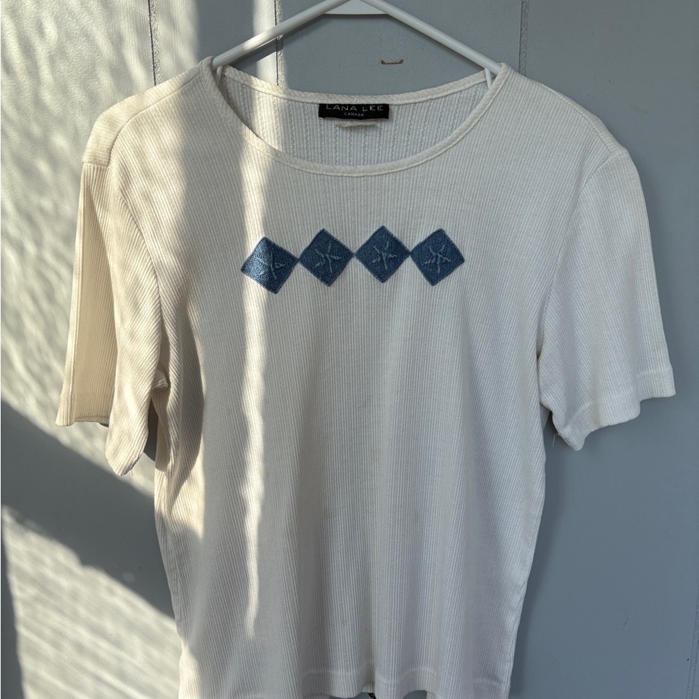 Elegant White Top with Blue Diamond Accents